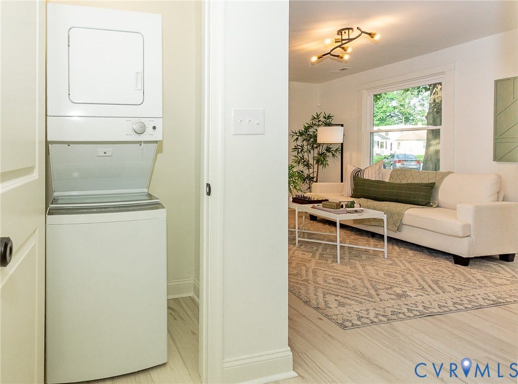 1601 N 25th Street, Richmond, VA 23223 Stackable washer and dryer unit, wood-finish flooring, white walls, and a contemporary ceiling light fixture