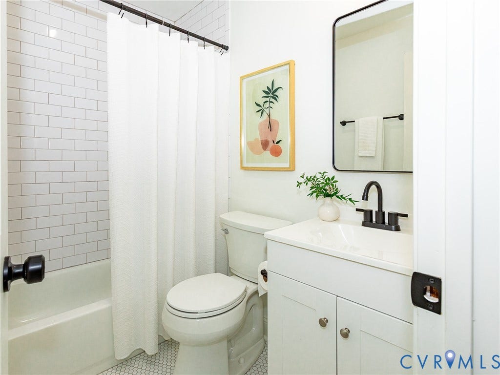 1601 N 25th Street, Richmond, VA 23223 White subway tile shower surround with a built-in tub