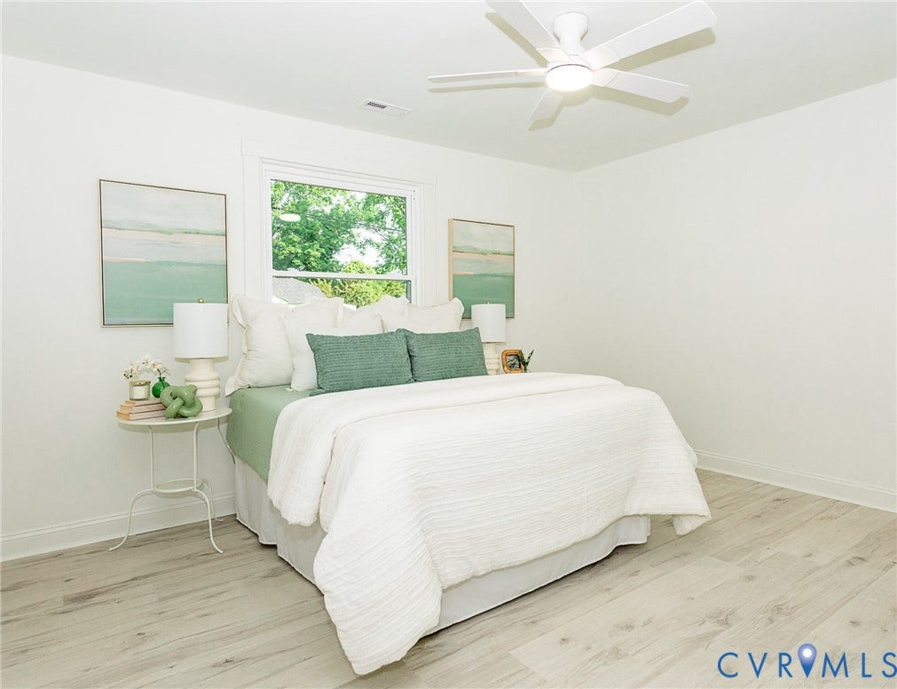 1601 N 25th Street, Richmond, VA 23223 White walls with a single window, a white ceiling fan with integrated lighting, and wood-finish flooring