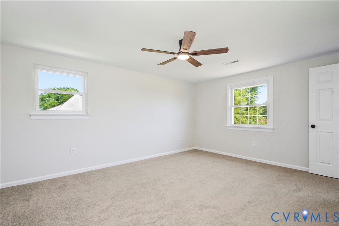 Neutral wall tones and plush carpet flooring