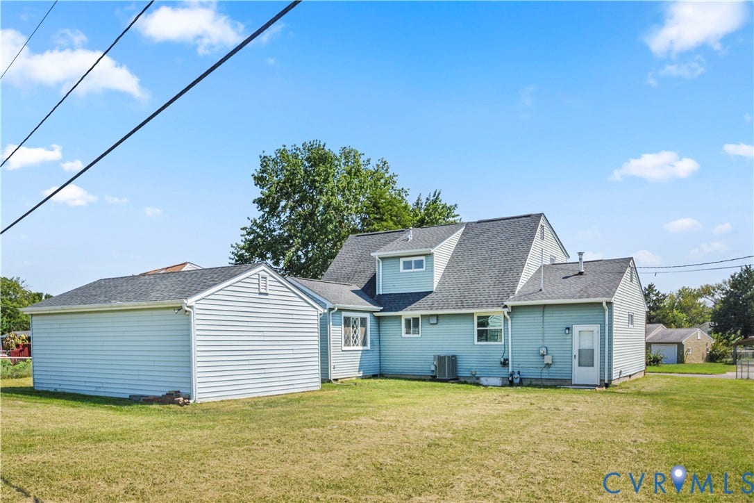 Light blue siding exterior with a dark shingle roof, featuring an attached garage with matching siding and roof