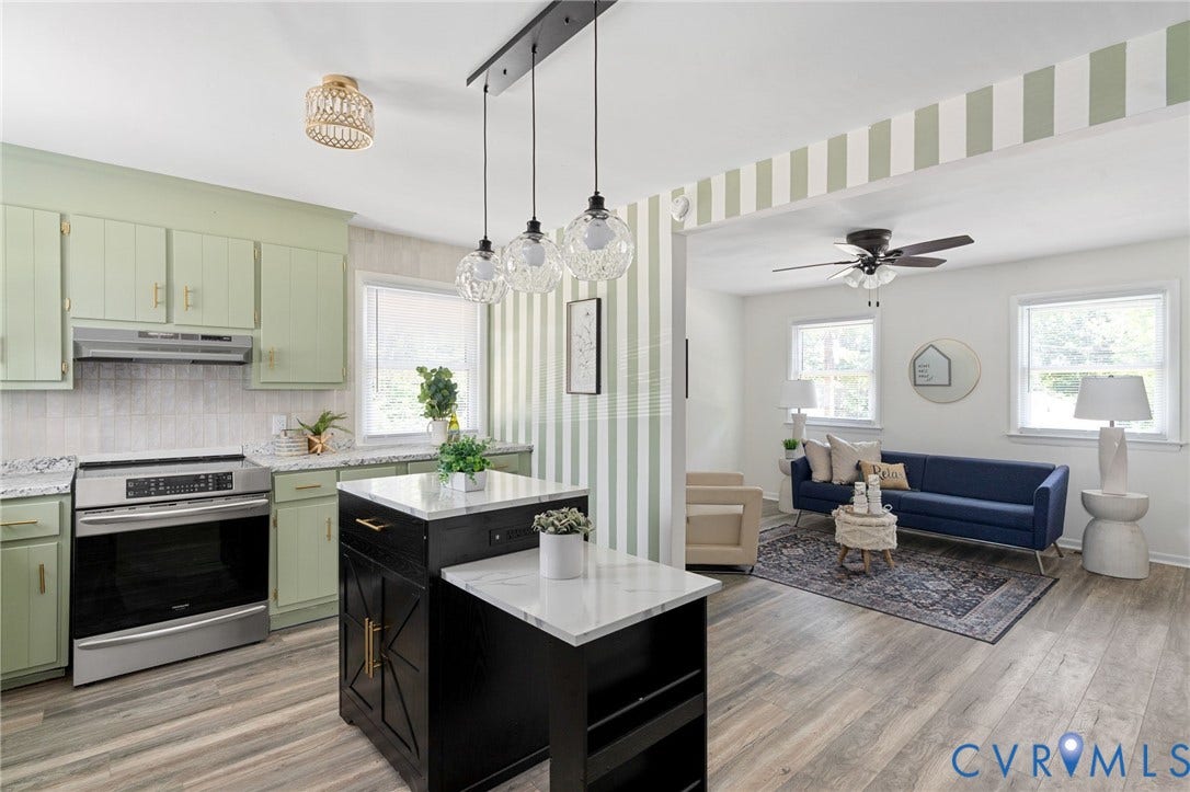 Kitchen with sage green cabinetry, stainless steel range, and stone-finish countertops