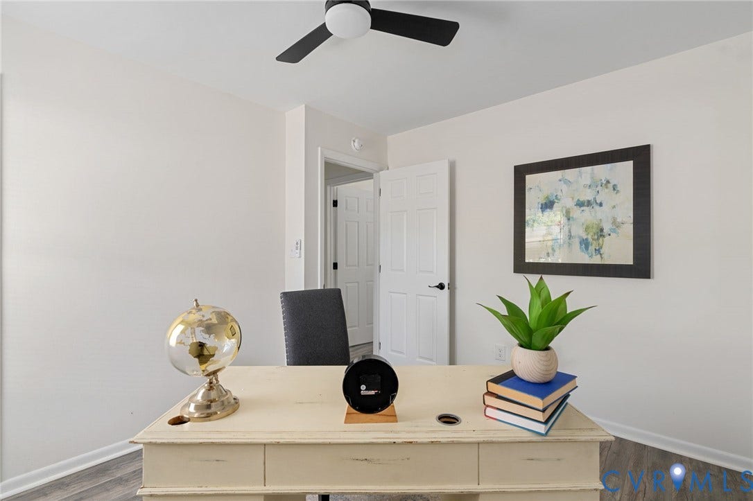 White walls, wood-finish flooring, ceiling fan, and paneled interior doors