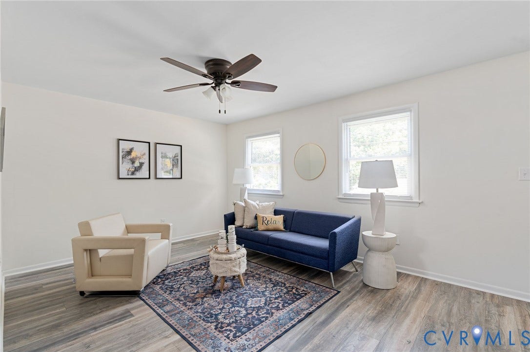 Wood-finish flooring, white walls, and a ceiling fan