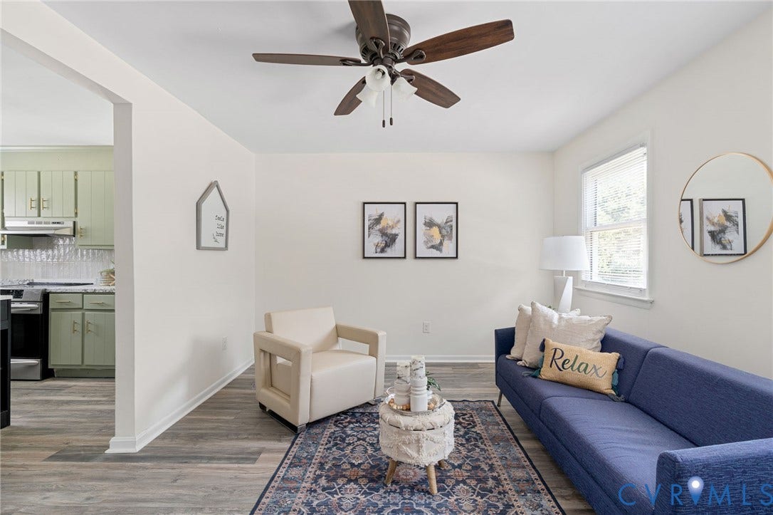 Wood-finish flooring throughout, ceiling fan with light fixture, and window with blinds