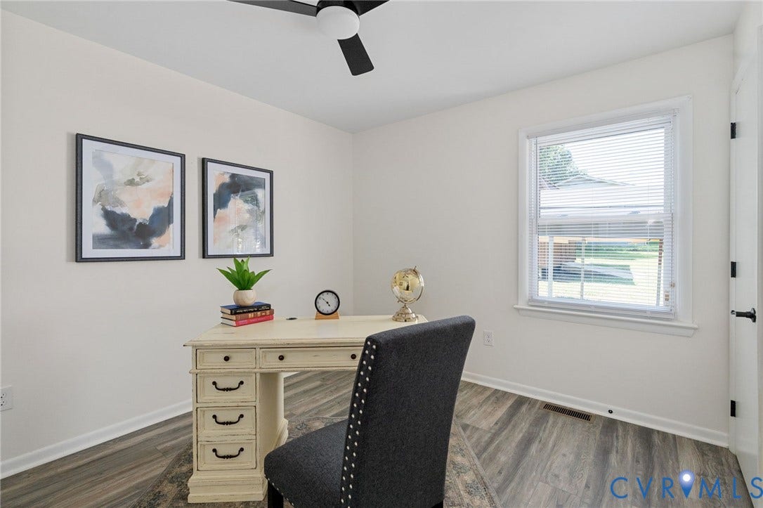 Neutral interior walls, wood-finish flooring, single window with blinds, ceiling fan, and white trim