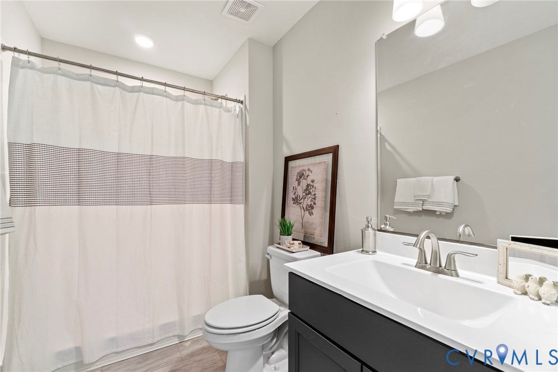 9143 Terroir Lane, Villas, New Kent, VA 23124 Modern vanity with an integrated sink, brushed nickel faucet, and a large wall-mounted mirror