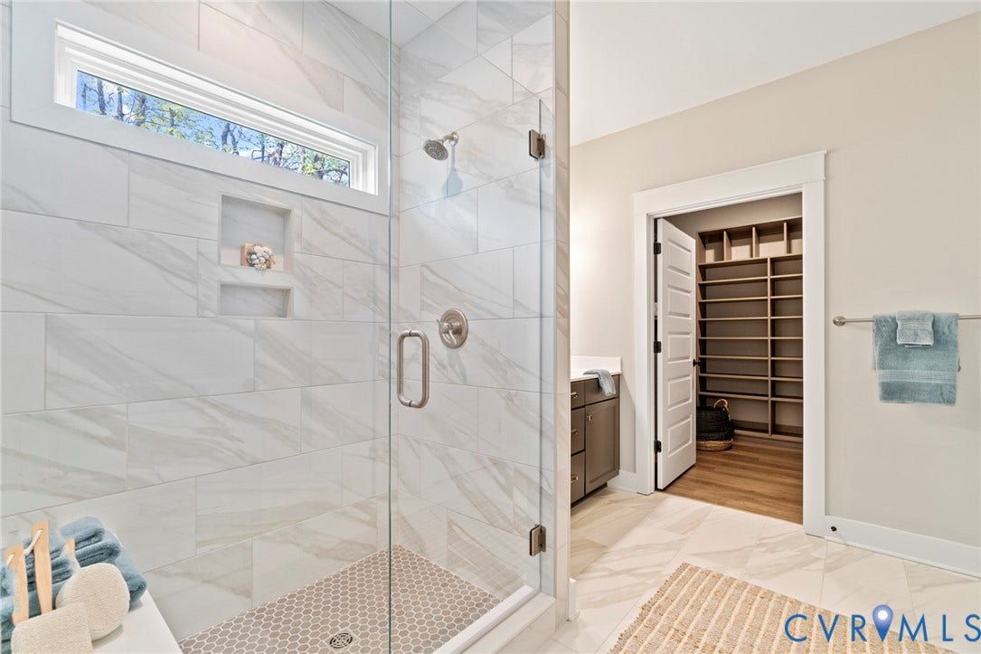9143 Terroir Lane, Villas, New Kent, VA 23124 Glass-enclosed shower with a tiled bench, two recessed niches, and a rainfall showerhead
