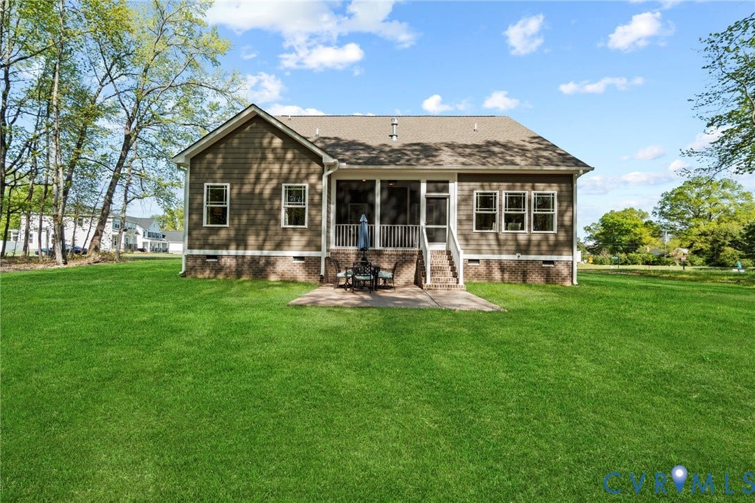 9143 Terroir Lane, Villas, New Kent, VA 23124 Expansive backyard with a manicured lawn, screened porch, rear patio, and a shingle roof