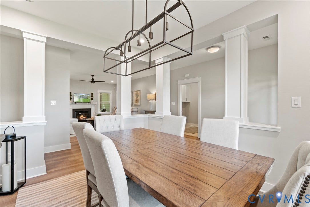 9143 Terroir Lane, Villas, New Kent, VA 23124 Dining area featuring wood-finish flooring, a linear chandelier, and decorative columns