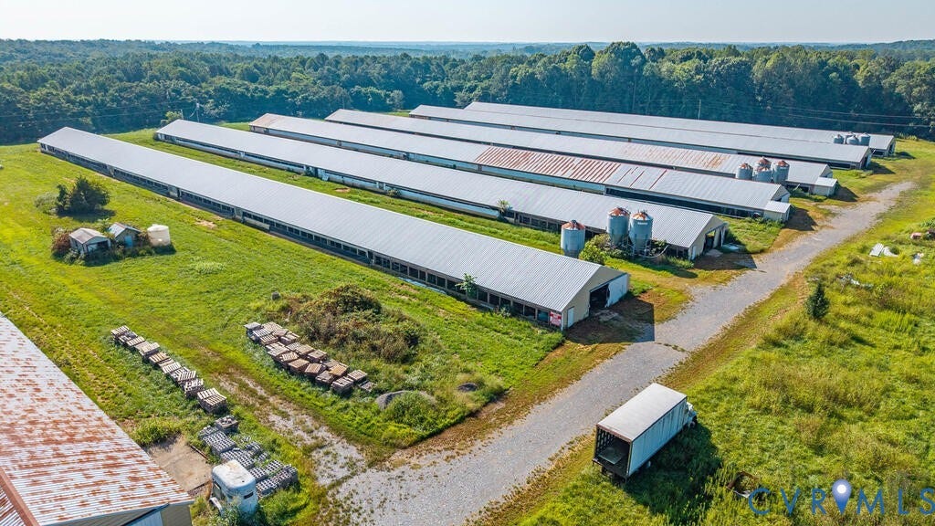 21 Vanderpool Lane, Detached, Cumberland, VA 23040 Multiple long structures with metal roofs, gravel driveways, and surrounding green spaces