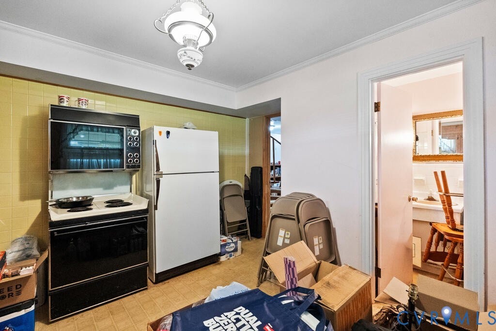 21 Vanderpool Lane, Detached, Cumberland, VA 23040 Built-in wall oven and range, freestanding refrigerator, tiled backsplash, ceiling-mounted light fixture, and crown molding