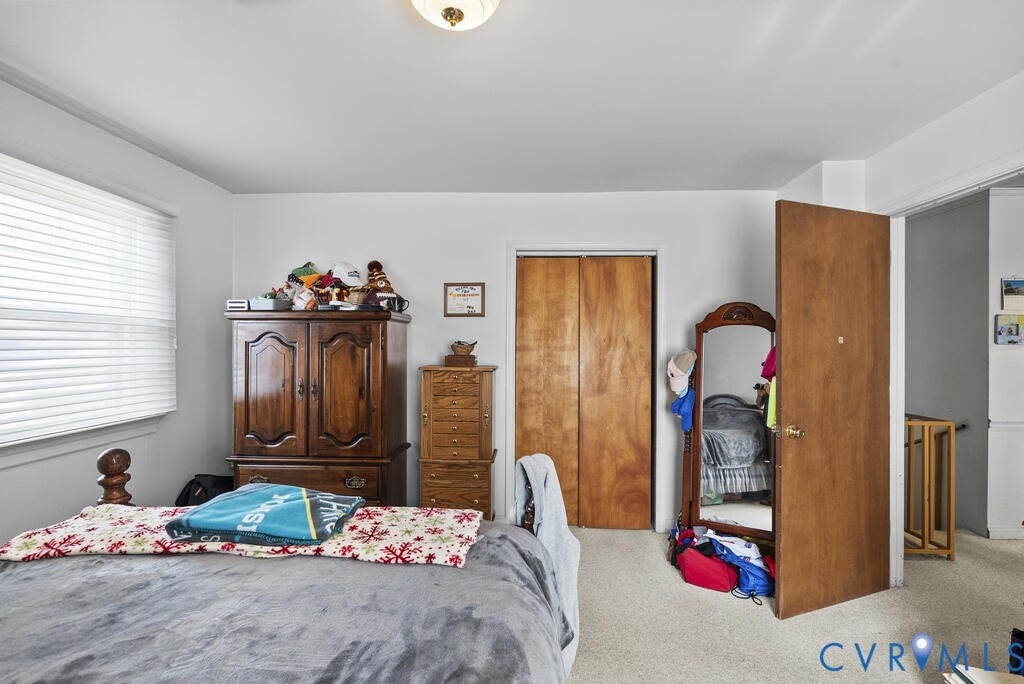 21 Vanderpool Lane, Detached, Cumberland, VA 23040 Wall-to-wall carpeting with light neutral walls, a window with horizontal blinds, and a built-in closet with wood bi-fold doors