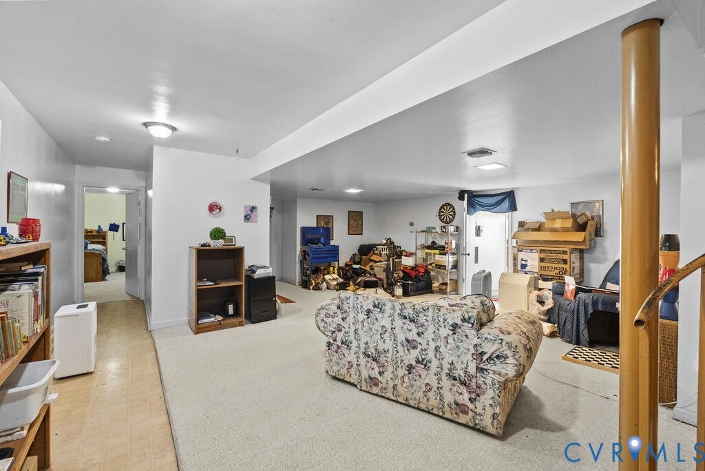21 Vanderpool Lane, Detached, Cumberland, VA 23040 Expansive open-concept space featuring recessed lighting, a neutral carpeted area, and a separate wood-finish flooring section