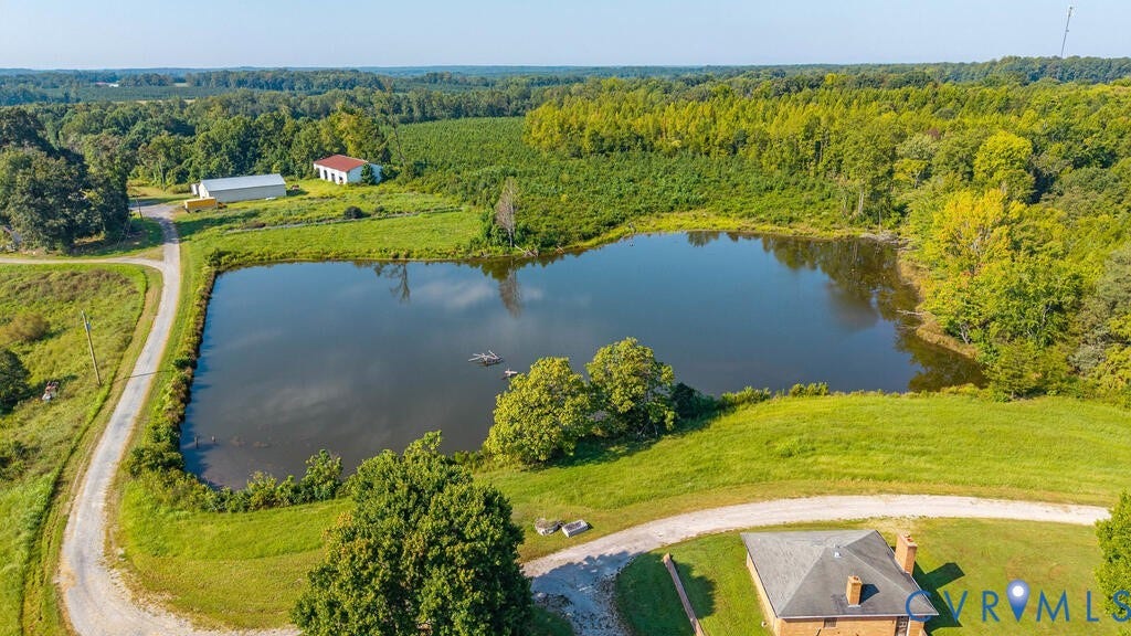 21 Vanderpool Lane, Detached, Cumberland, VA 23040 Expansive property featuring a large pond, surrounding green landscape, and a gravel driveway