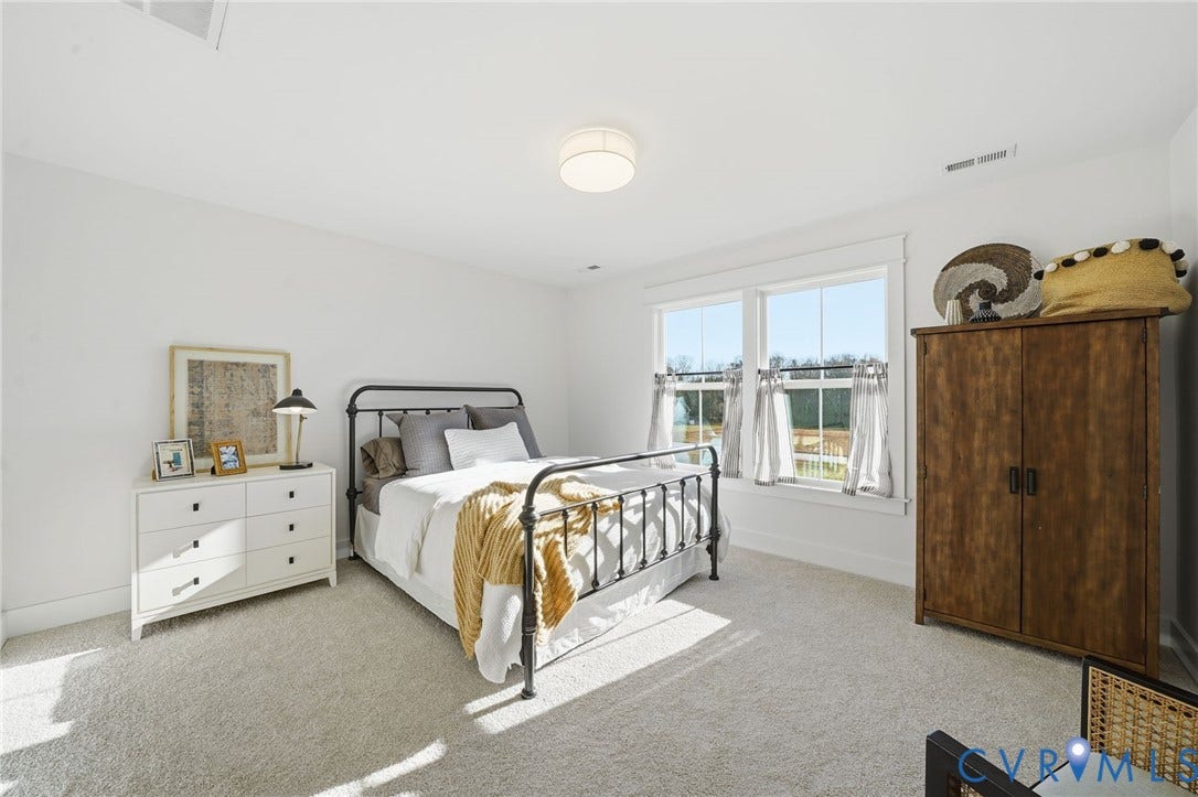 9169 Terroir Lane, Villas, New Kent, VA 23124 Plush carpeting, bright white walls, a contemporary ceiling light fixture, and a pair of windows with white trim