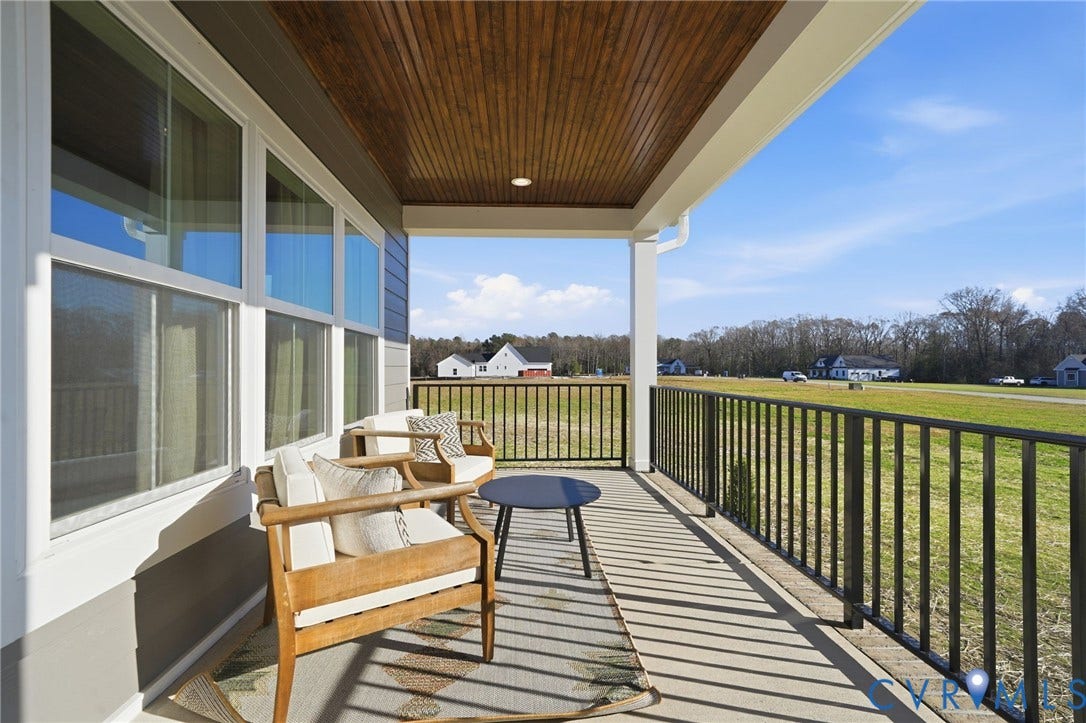 9169 Terroir Lane, Villas, New Kent, VA 23124 Covered porch with a wood-finish ceiling, multiple windows, and dark metal railing