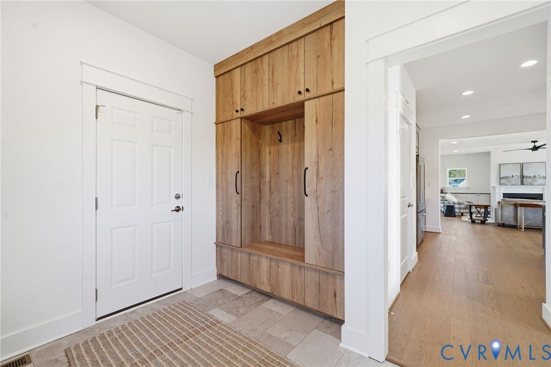 9169 Terroir Lane, Villas, New Kent, VA 23124 Built-in wood-finish cabinetry with black hardware, recessed lighting, white interior doors, and wood-finish flooring