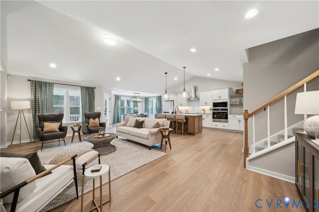 9102 Terroir Lane, Viniterra Villas, New Kent, VA 23124 Expansive open-concept living area featuring wood-finish flooring, vaulted ceilings, and recessed lighting