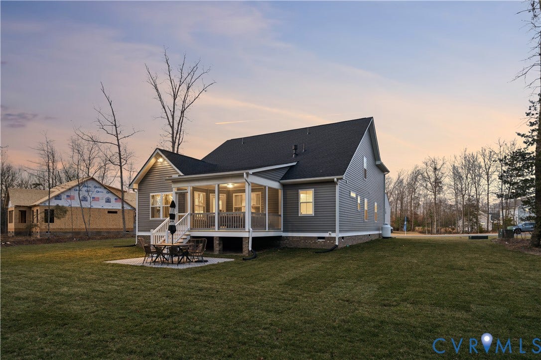 9102 Terroir Lane, Viniterra Villas, New Kent, VA 23124 Gray siding exterior with white trim, dark shingle roofing, and a screened-in porch