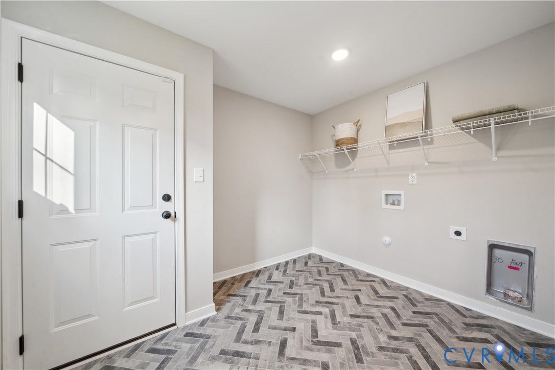 9102 Terroir Lane, Viniterra Villas, New Kent, VA 23124 Laundry area featuring herringbone-pattern wood-finish flooring, built-in wire shelving, and overhead recessed lighting