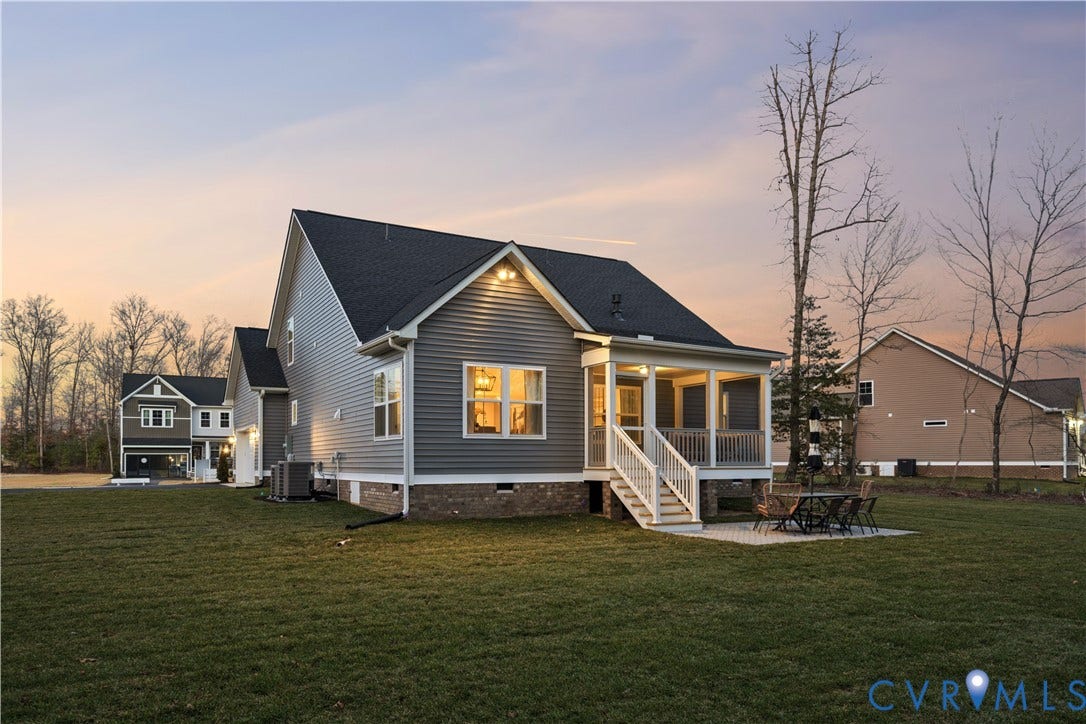 9102 Terroir Lane, Viniterra Villas, New Kent, VA 23124 Expansive rear yard with a screened porch, paver patio, and dark gray siding