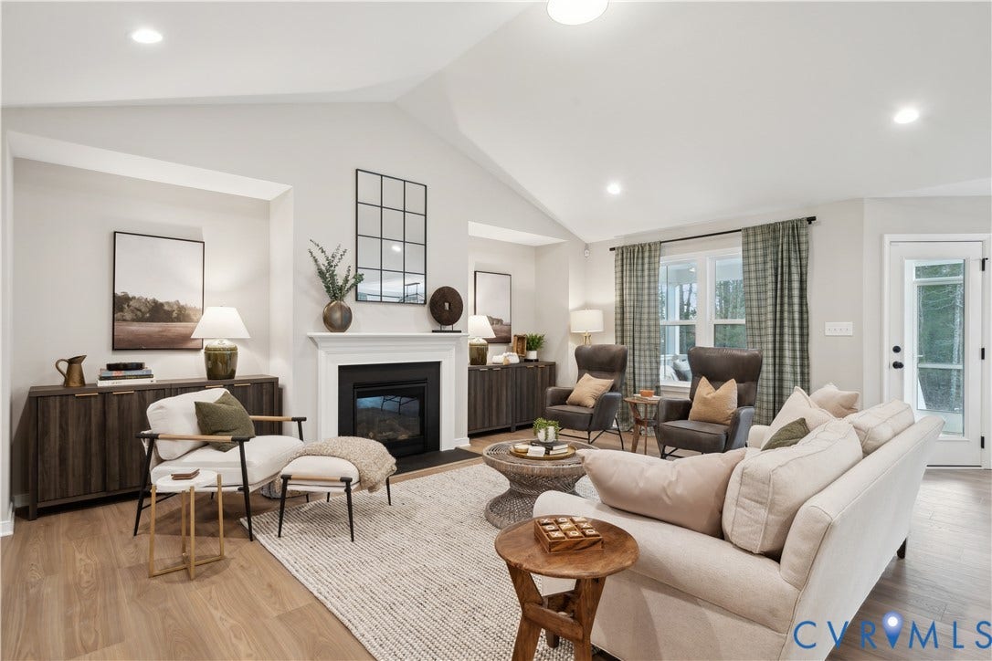 9102 Terroir Lane, Viniterra Villas, New Kent, VA 23124 Vaulted ceiling with recessed lighting, wood-finish flooring, white mantel fireplace, and a glass-paneled exterior door
