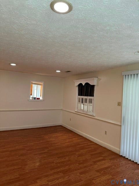 7617 Sunny Bank Drive, Henrico, VA 23228 Recessed ceiling lighting, wood-finish flooring, white wall paneling, and multiple windows