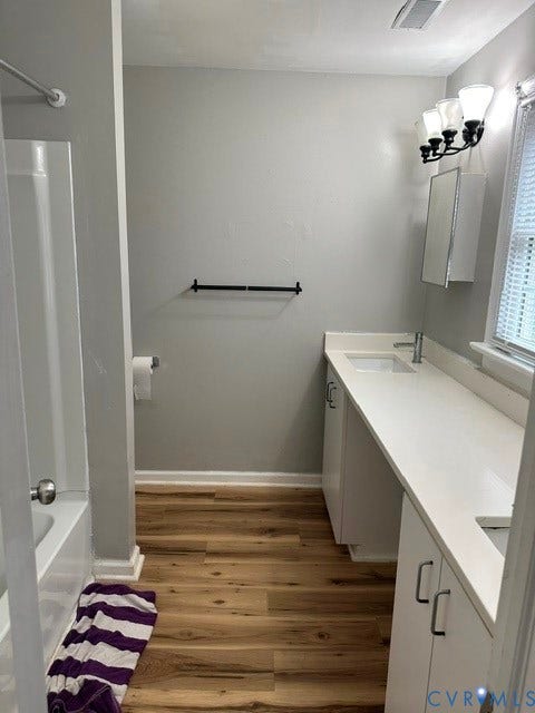7617 Sunny Bank Drive, Henrico, VA 23228 Dual vanity with undermount sinks, white cabinetry, and a continuous white countertop