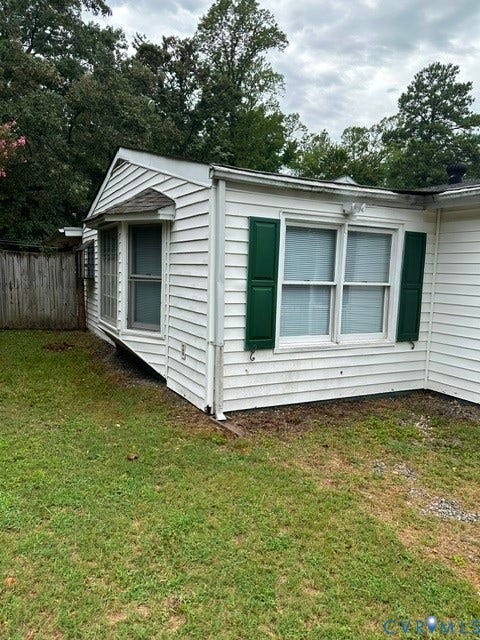 7617 Sunny Bank Drive, Henrico, VA 23228 White vinyl siding exterior with green shutters, featuring a bay window with an awning