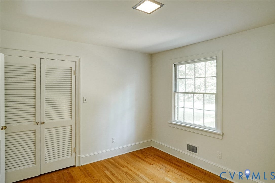 1407 W Monmouth Court, Henrico, VA 23238 Bedroom #2 with hardwood flooring, louvered bi-fold closet doors and overhead lighting.