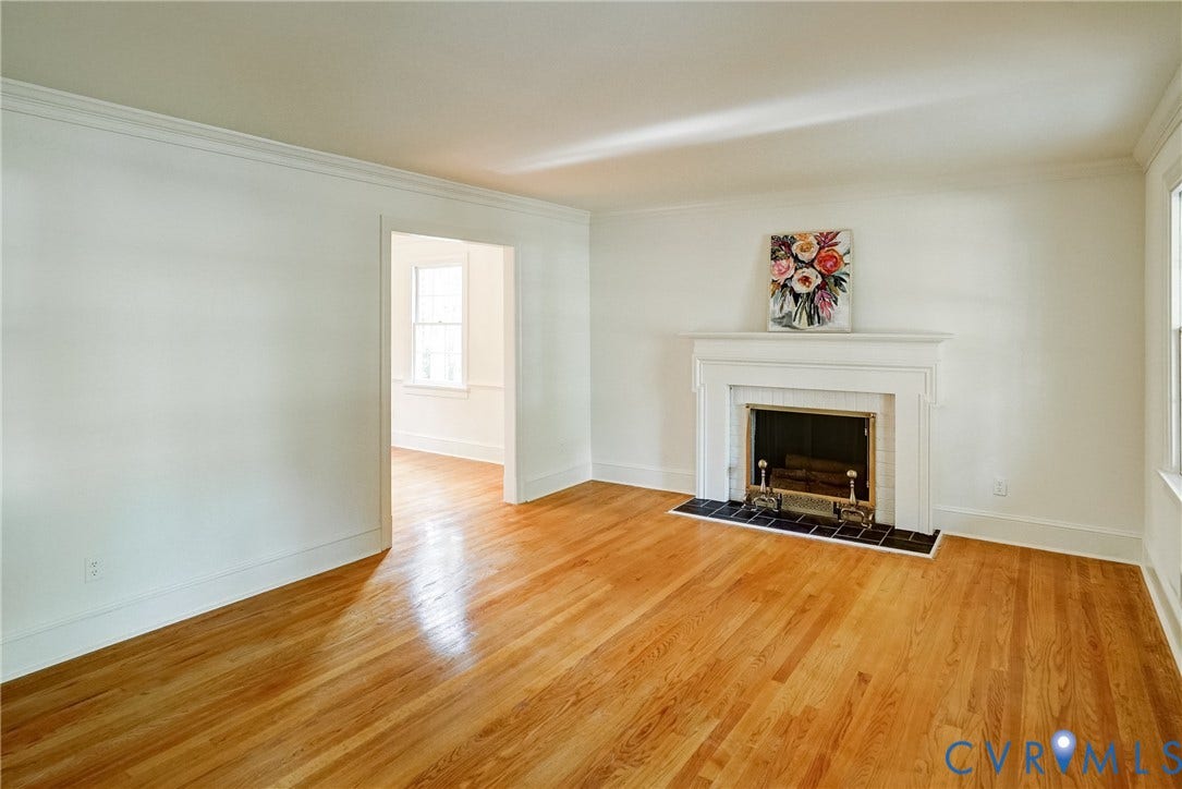 1407 W Monmouth Court, Henrico, VA 23238 Spaciouse living room with hardwood flooring, crown molding and fireplace with mantle. Opens to dining room