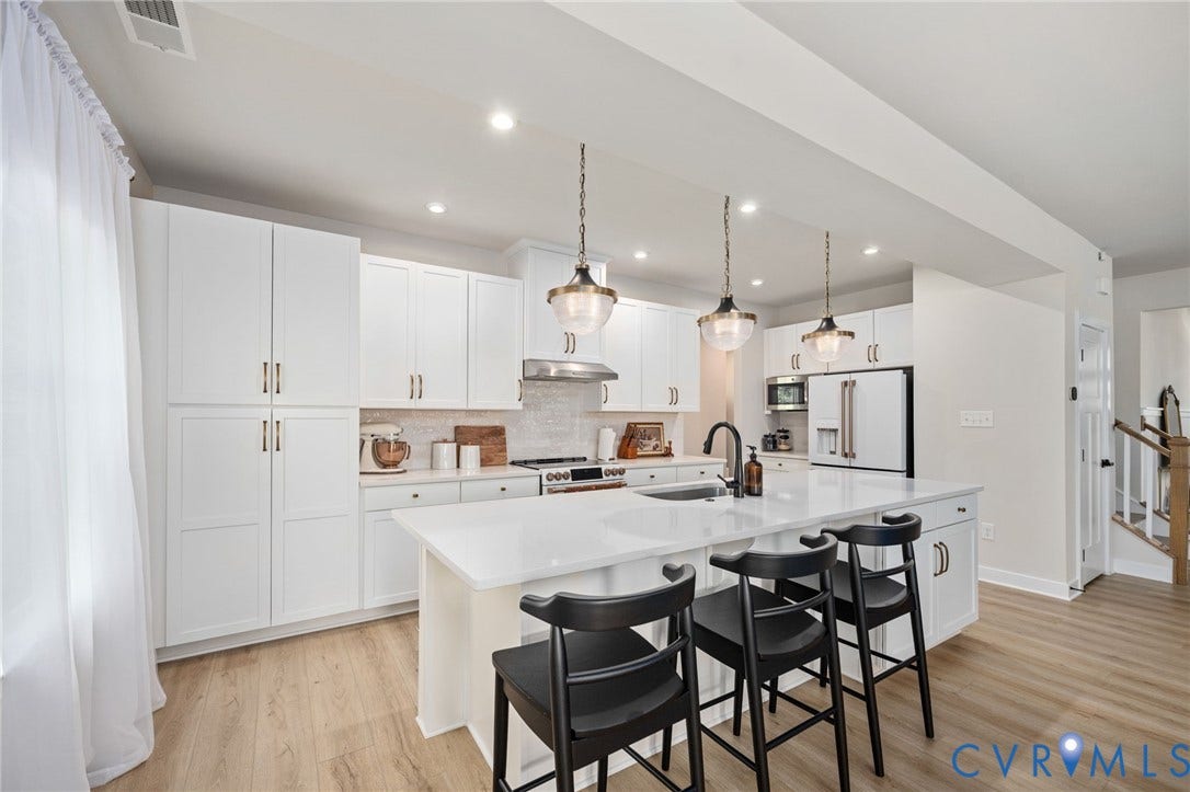 1961 Enon Station Drive, Chester, VA 23836 Expansive kitchen island, stainless steel appliances, recessed lighting, wood-finish flooring, and white cabinetry