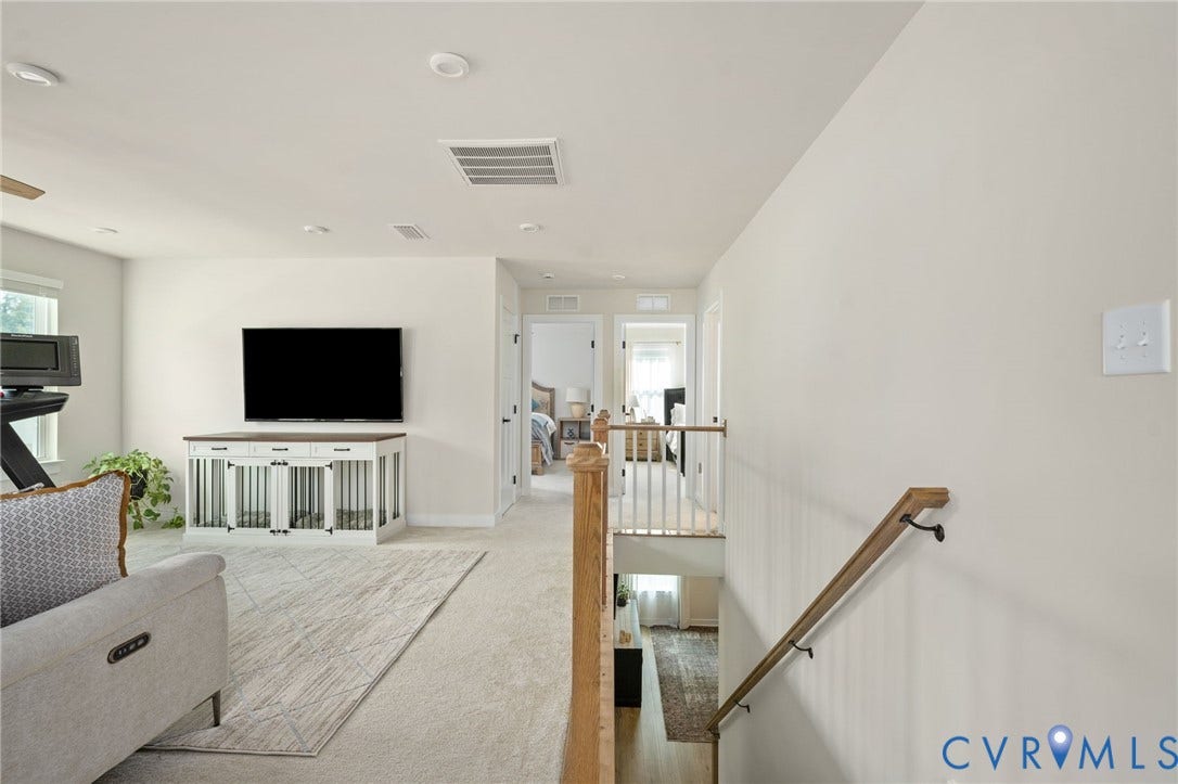 1961 Enon Station Drive, Chester, VA 23836 Carpeted living area featuring recessed lighting, a ceiling fan, and a light wood railing with dark metal balusters