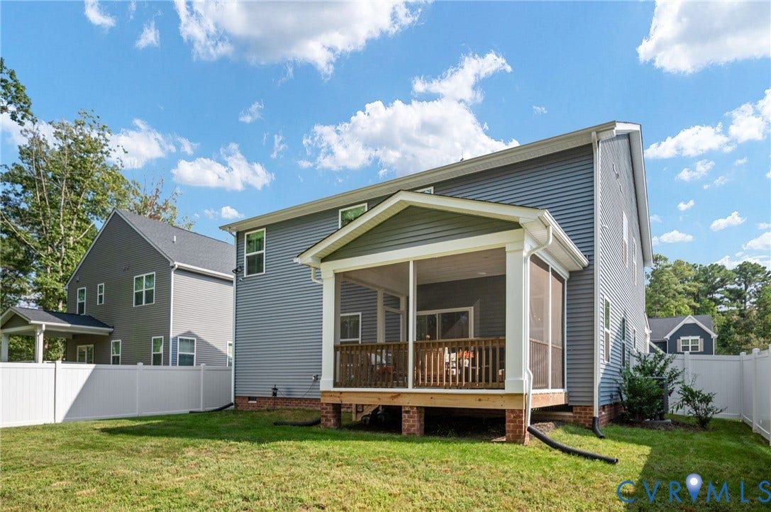 1961 Enon Station Drive, Chester, VA 23836 Spacious backyard featuring a screened porch, white vinyl fencing, and a manicured lawn