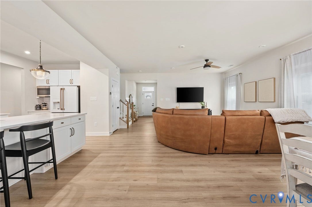 1961 Enon Station Drive, Chester, VA 23836 Open-concept living area featuring wood-finish flooring, white cabinetry, a built-in kitchen island with a light-toned countertop, and recessed lighting