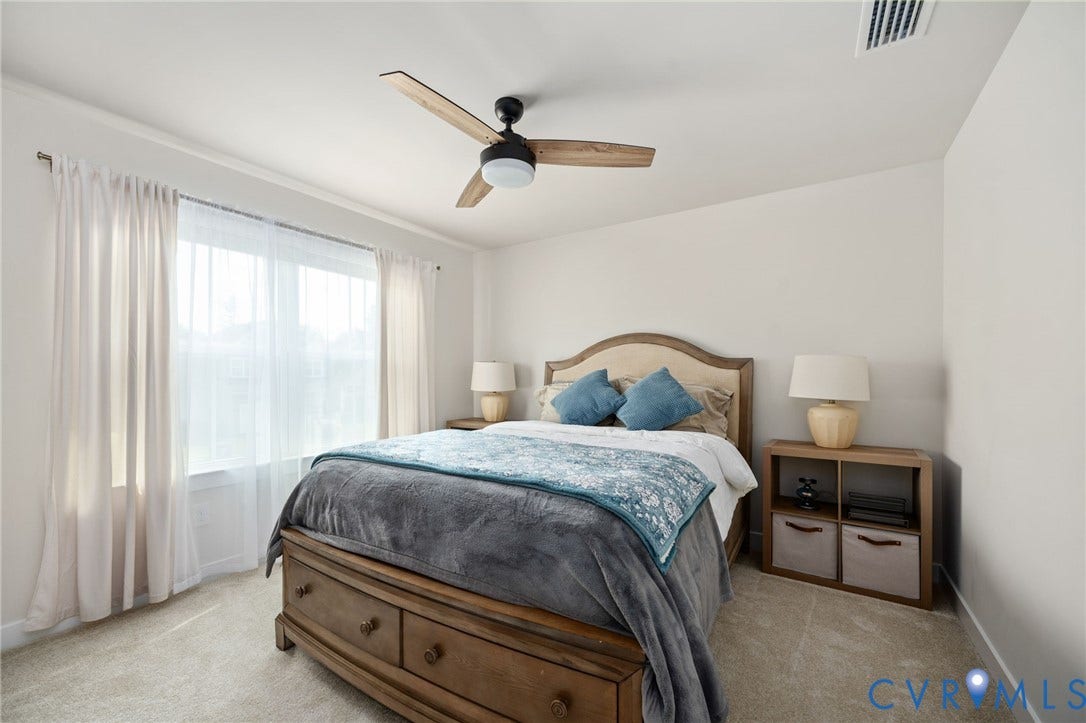 1961 Enon Station Drive, Chester, VA 23836 Large window with sheer and blackout drapery, ceiling fan with wood-finish blades, and neutral carpet flooring