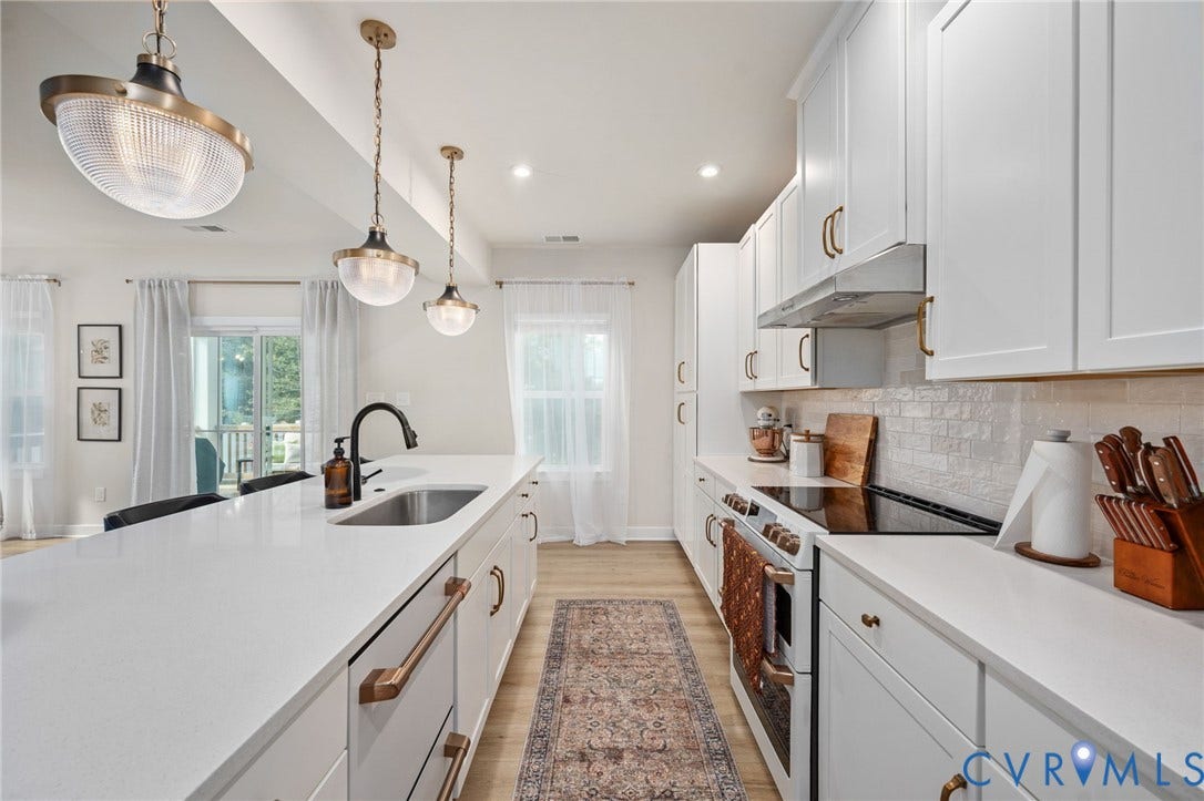 1961 Enon Station Drive, Chester, VA 23836 Kitchen featuring white cabinetry, light-toned countertops, a stainless steel sink with a dark-finish faucet, and pendant lighting