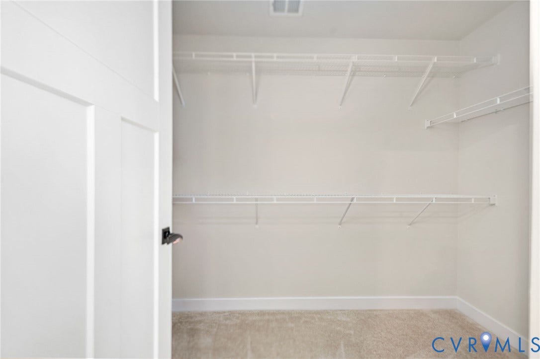 1961 Enon Station Drive, Chester, VA 23836 White wire shelving system, light neutral wall paint, and beige carpet flooring