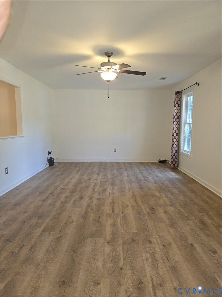 289 Winding Ridge Way, Winding Ridge, Bumpass, VA 23024 Spacious room featuring wood-finish flooring, white walls, and a ceiling fan with integrated lighting