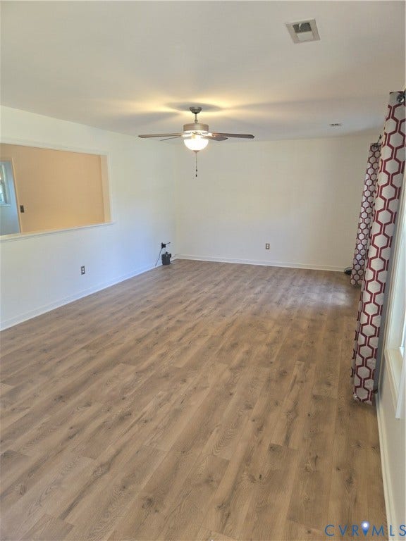 289 Winding Ridge Way, Winding Ridge, Bumpass, VA 23024 Spacious interior with light wood-finish flooring, a ceiling fan with integrated lighting, and a partial wall separating areas