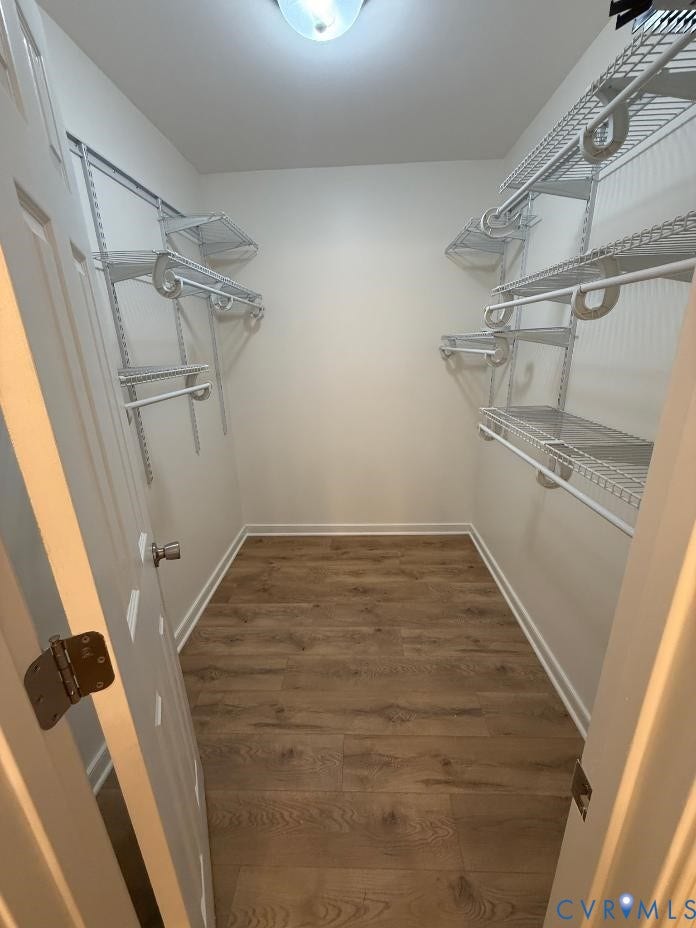 289 Winding Ridge Way, Winding Ridge, Bumpass, VA 23024 Wood-finish flooring with white baseboards, a flush-mount ceiling light, and white wire shelving