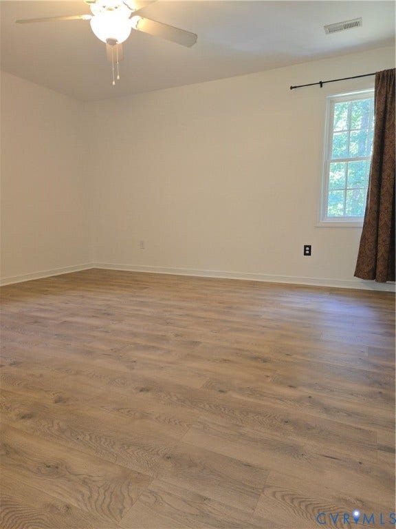 289 Winding Ridge Way, Winding Ridge, Bumpass, VA 23024 Wood-finish flooring, white walls, ceiling fan, and a window with trim