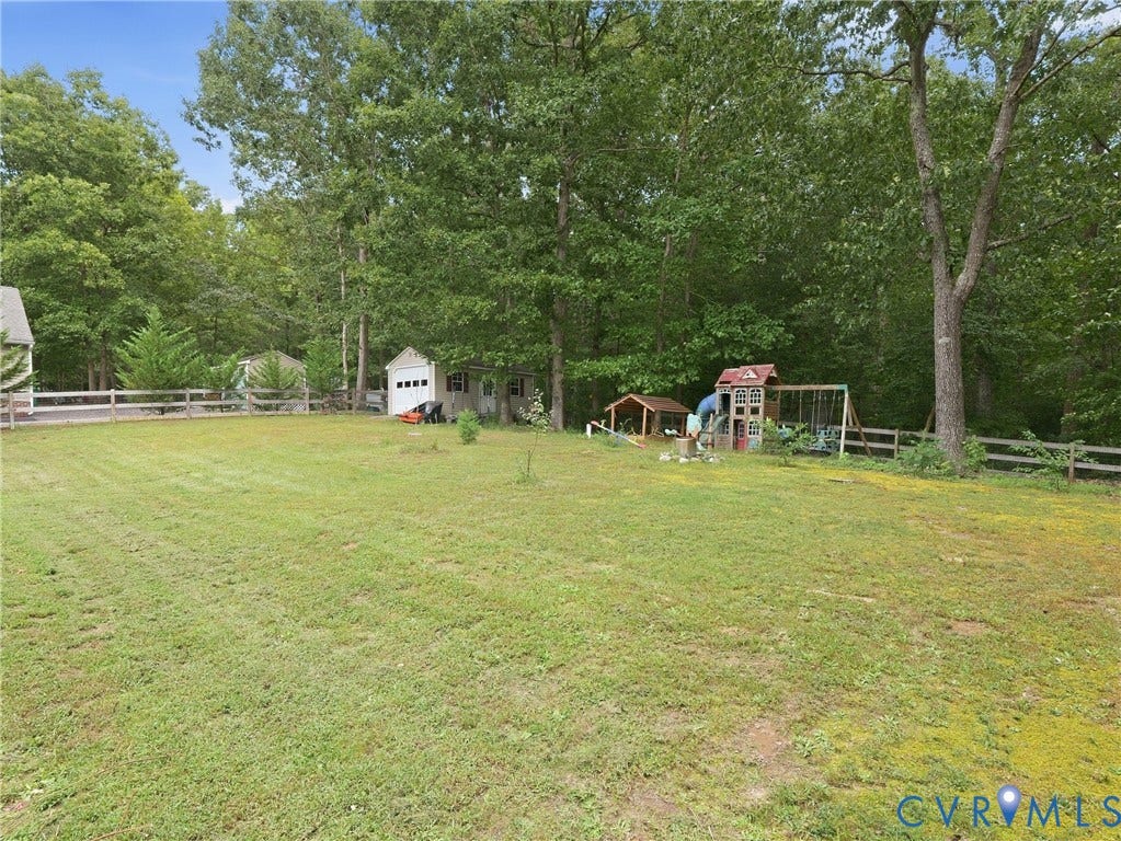 8325 Caroline Vines Way, Estates At Willis Church, Henrico, VA 23231 Expansive grassy area featuring a wooden fence and mature trees