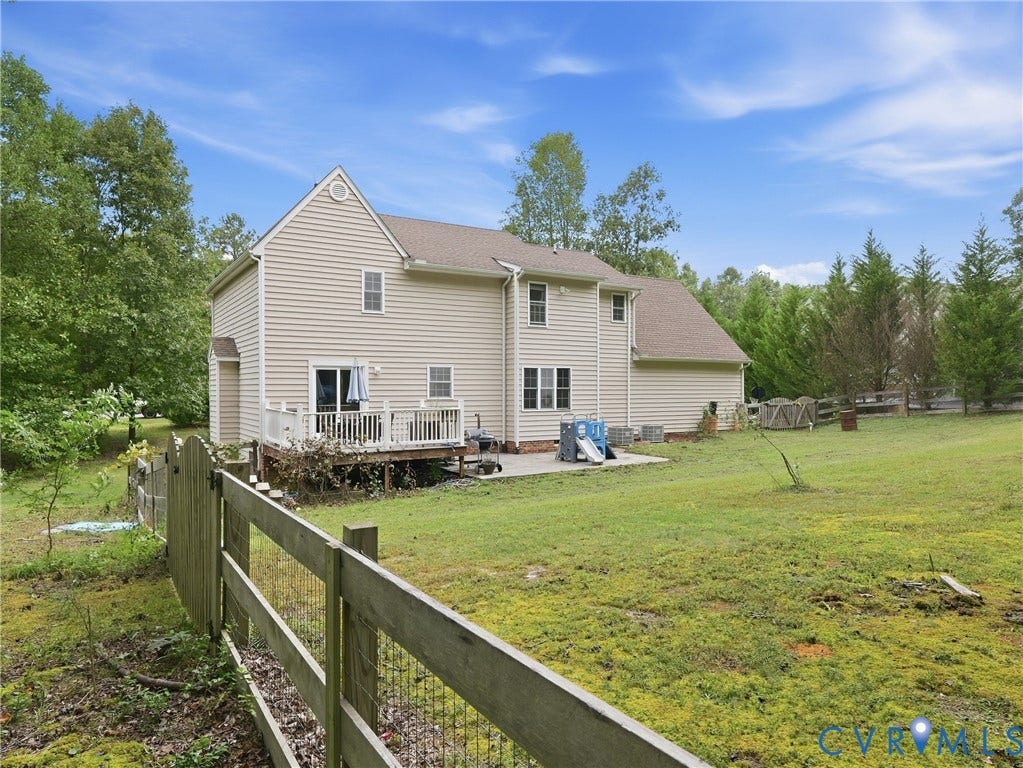 8325 Caroline Vines Way, Estates At Willis Church, Henrico, VA 23231 Expansive backyard with a wood fence, mature trees, a multi-level deck, and a ground-level patio