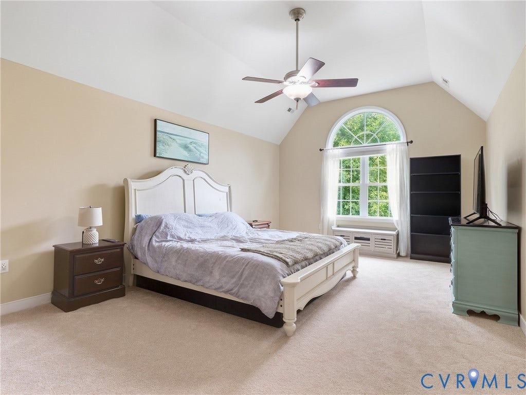 8325 Caroline Vines Way, Estates At Willis Church, Henrico, VA 23231 Vaulted ceiling with ceiling fan, arched window, wall-to-wall carpeting, and neutral wall tones