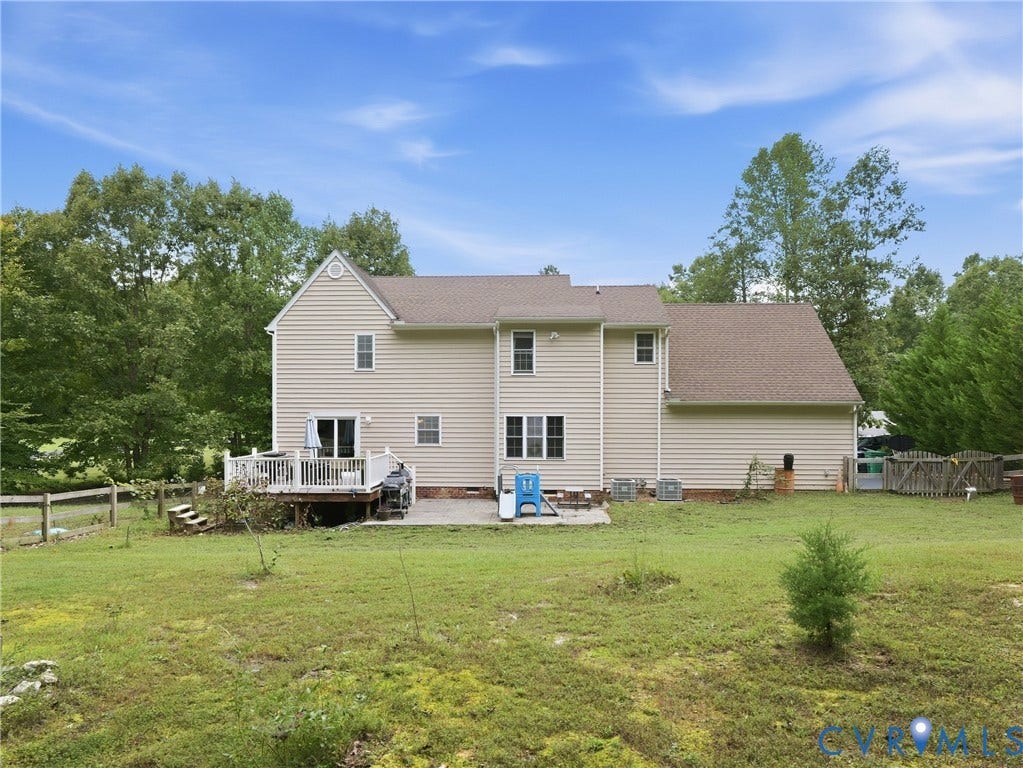 8325 Caroline Vines Way, Estates At Willis Church, Henrico, VA 23231 Expansive backyard with a wooden deck, a ground-level patio, and a partial wooden fence