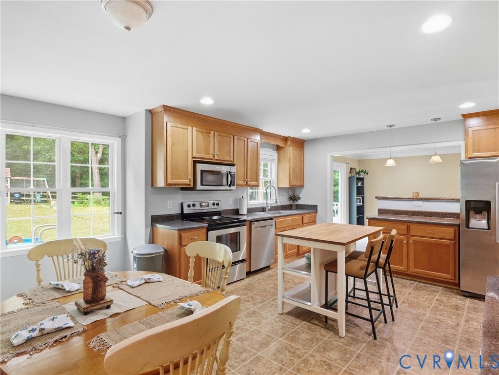 8325 Caroline Vines Way, Estates At Willis Church, Henrico, VA 23231 Full kitchen with wood cabinetry, stainless steel appliances, and tiled flooring