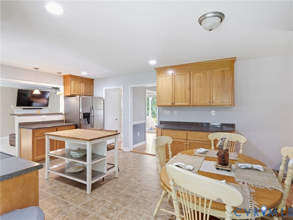 8325 Caroline Vines Way, Estates At Willis Church, Henrico, VA 23231 Kitchen featuring wood cabinetry, stainless steel refrigerator, granite-style countertops, and tiled flooring