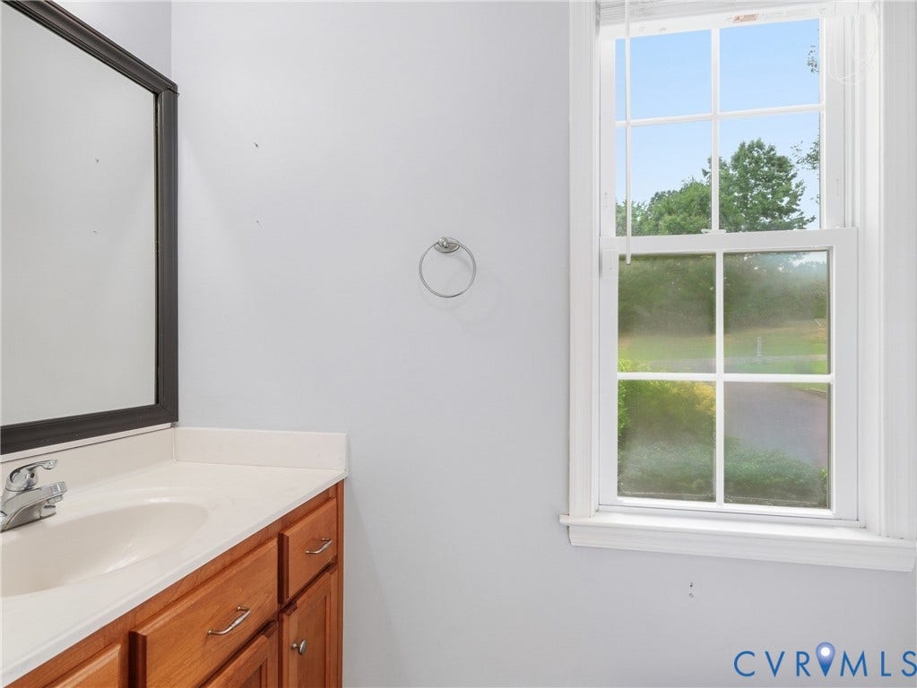 8325 Caroline Vines Way, Estates At Willis Church, Henrico, VA 23231 Wood-finish vanity with an integrated sink and chrome faucet